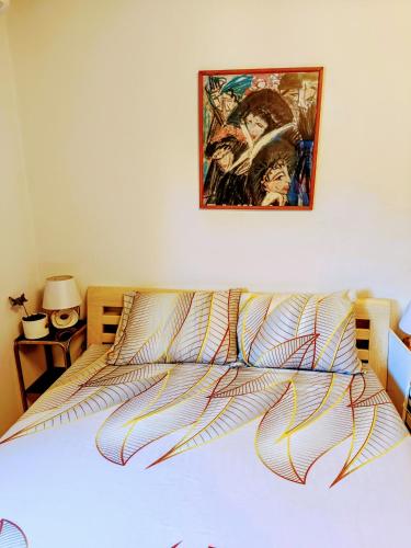 a bedroom with a bed with a painting on the wall at Jupiter in Split