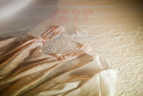 a painting of a dress on a table with a number at Casa Velarde in Torrelavega