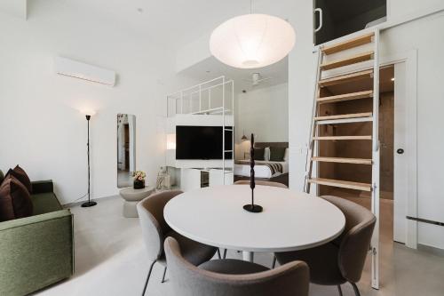 a living room with a white table and chairs at Gran Turia Apartments in Valencia