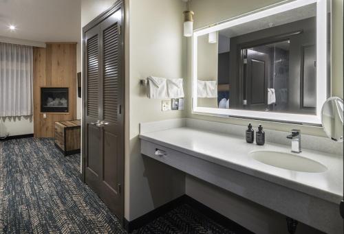 a bathroom with a sink and a mirror at The Rockwell Inn in Jackson