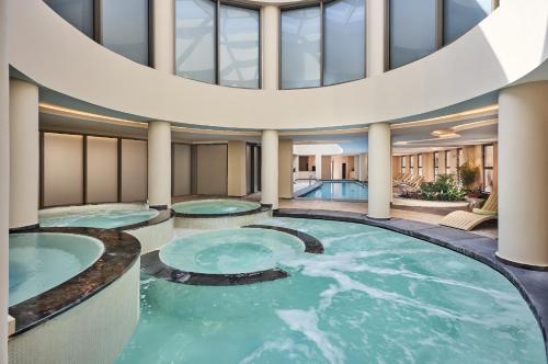 a pool in a hotel lobby with two hot tubs at Liberty Signa in Fethiye
