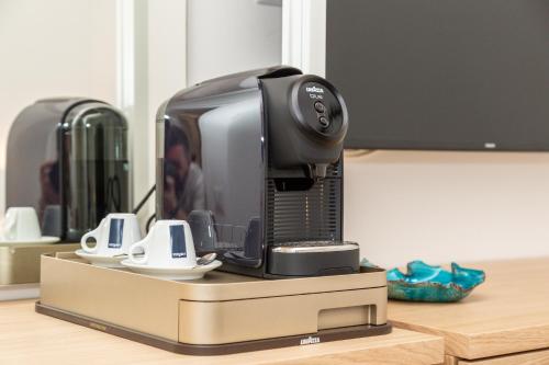a coffee maker sitting on top of a counter at Aras Hotel Boutique in Villasimius