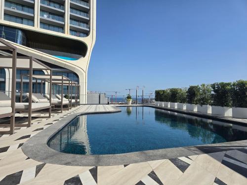 a swimming pool on the side of a building at Mercury Suites - Skydream Getaways in St. Julianʼs