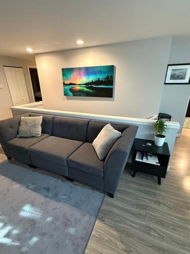 a living room with a couch and a painting on the wall at Queen Anne Retreat - 3BR Haven in the heart of Seattle in Seattle