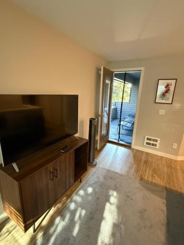a living room with a large flat screen tv at Queen Anne Retreat - 3BR Haven in the heart of Seattle in Seattle