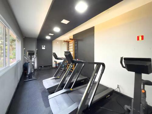 a gym with treadmills and machines in a room at AP BOHO 1010 Brás - Piscina Aquecida, WiFi, Academia, Cama Casal box e colchão extra solteiro in Sao Paulo