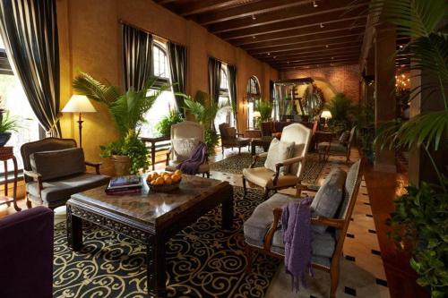 a living room with chairs and a table at The Mission Inn Hotel and Spa in Riverside