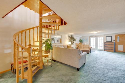 a living room with a spiral staircase in a house at 3 Mi to Garden of the Gods Quiet Home with Hot Tub! in Colorado Springs
