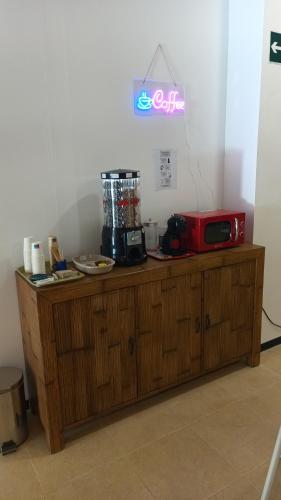 a wooden cabinet with a microwave on top of it at Hostel Elios in Lorca