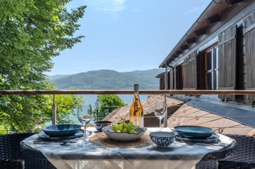 a table with a bowl of grapes and a bottle of wine at 2 Bedroom Apartment with access to Attersee Lake in Seewalchen