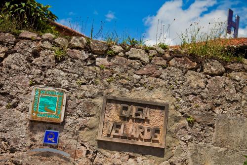 a stone wall with a sign on top of it at Casa Velarde in Torrelavega