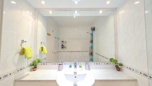 a bathroom with a sink and a large mirror at CSS Cheerful Smart Superior 2BD Townhouse Limnaria Gardens in Paphos City
