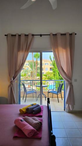 a bedroom with a bed with a view of a balcony at CSS Cheerful Smart Superior 2BD Townhouse Limnaria Gardens in Paphos City