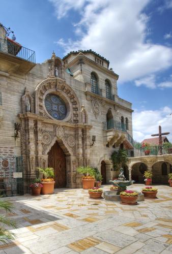 a large stone building with potted plants in front of it at The Mission Inn Hotel and Spa in Riverside