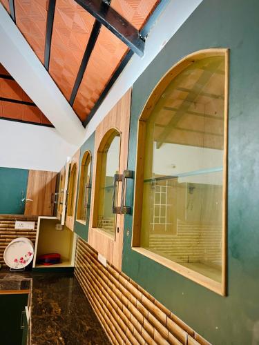 a room with two large windows in a kitchen at Rooms For Rent Near Isha ,Kovai Kutrallam in Alāndurai