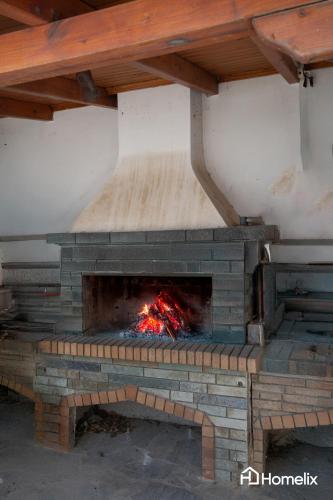 a brick oven with a fire inside of it at Fivi in Áyios Nikólaos