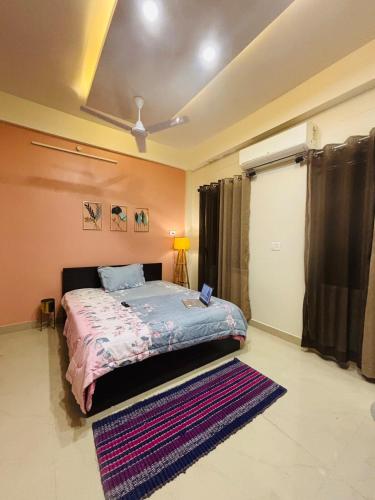 a bedroom with a bed and a rug at Miss Tea Home in Agartala