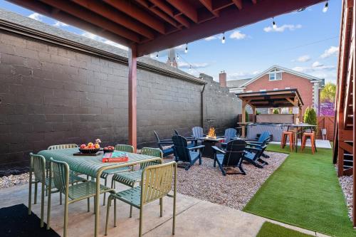 a patio with a table and chairs on the grass at The Rickhouse - Elegance & Fun Wrapped In One! in Louisville