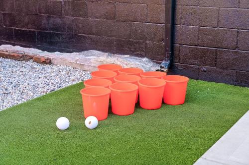 a group of orange cups sitting on the grass at The Rickhouse - Elegance & Fun Wrapped In One! in Louisville