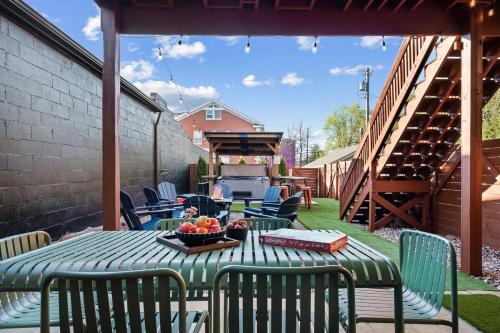 a table with chairs and a bowl of fruit on a patio at The Rickhouse - Elegance & Fun Wrapped In One! in Louisville