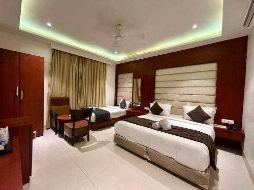a hotel room with two beds and a desk at Hotel Z Suites - Delhi Airport- FREE Airport Pickup & Drop in New Delhi