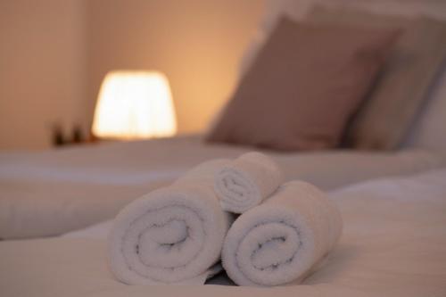 a pile of towels sitting on top of a bed at Churfirsten Blick- Charme mit Aussicht & Liftnähe in Quarten