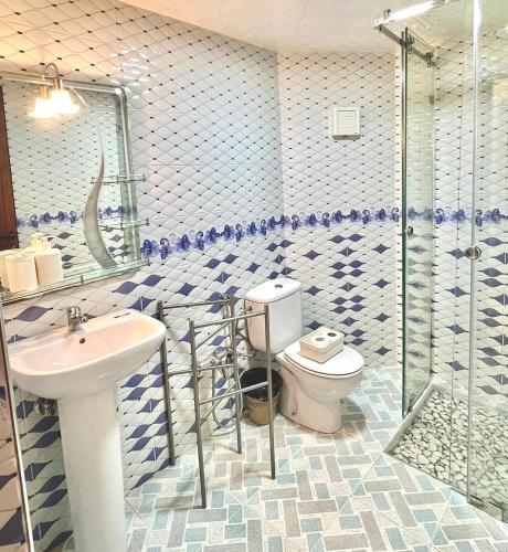 a bathroom with a toilet and a sink and a shower at Marakech home in Marrakesh