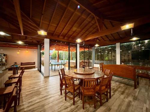 a dining room with a table and wooden chairs at Puxadinho São Pedro in São Pedro