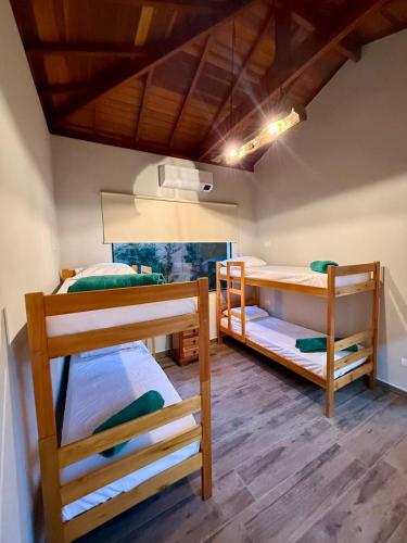a room with three bunk beds in it at Puxadinho São Pedro in São Pedro