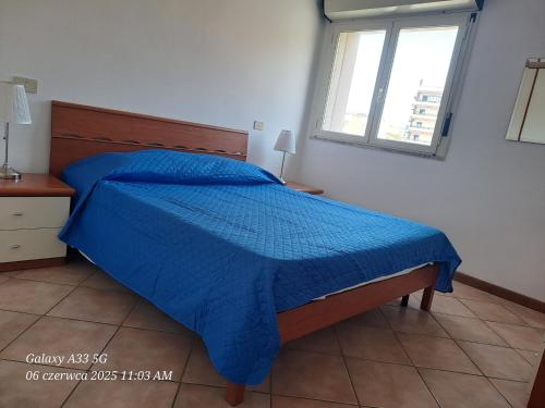 En eller flere senge i et værelse på Appartamento Spiaggia