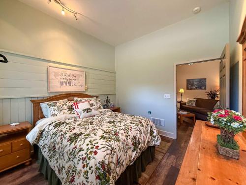 a bedroom with a bed and a living room at Dragonfly Haven in Sequim