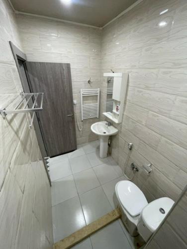 a small bathroom with a toilet and a sink at Appart - Hotel AS in Aïn El Turk