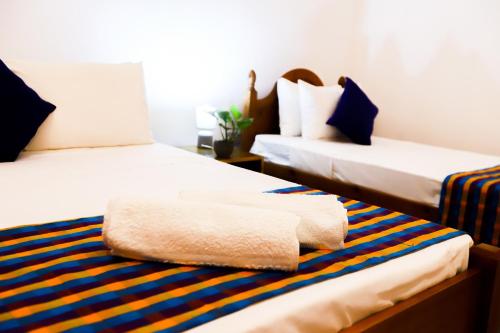 Postel nebo postele na pokoji v ubytování Lagoon House Negombo