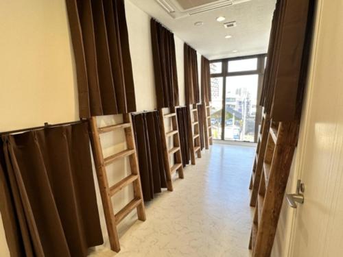 a hallway with a row of black curtains and a door at Monarch Hotel - Vacation STAY 42994v in Otaru