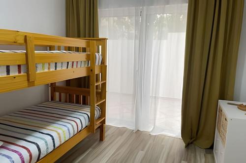 a bedroom with bunk beds and a large window at Sweet Home Bayahibe in Bayahibe