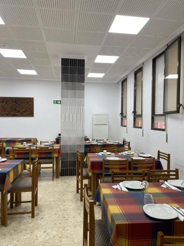 a dining room with wooden tables and chairs at Albergue Rosa Molas in Arrabal de Jesús