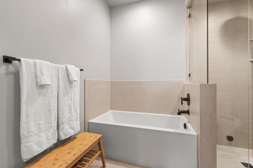 a bathroom with a white tub and a shower at Spacious 4-bedroom Townhome New Black Rock in Kamas