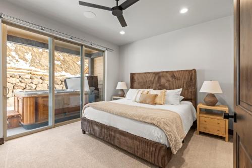 a bedroom with a bed and a sliding glass door at Spacious 4-bedroom Townhome New Black Rock in Kamas