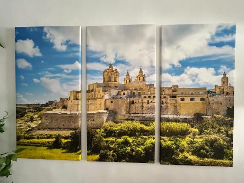 a picture of a castle against a blue sky at St Paul’s Bay central apartment in Qawra in St Paul's Bay