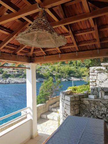 a patio with a view of the water at Jube vacation in Žrnovo