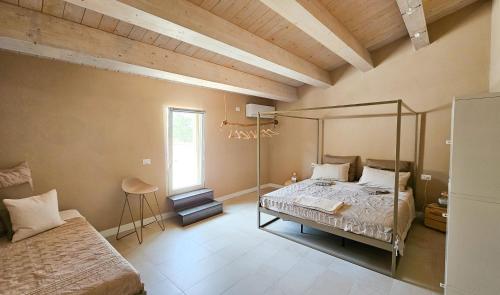 a bedroom with a canopy bed and a window at Kaikna Podere Evolutivo in Montescudaio