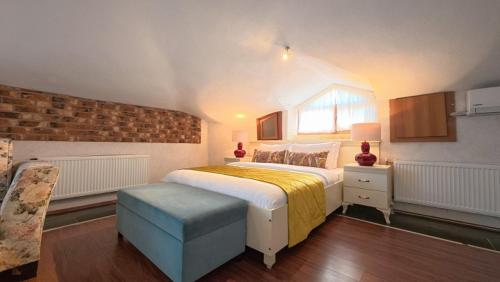 a bedroom with a large bed and a brick wall at Casa Villa By Kirte in Eceabat