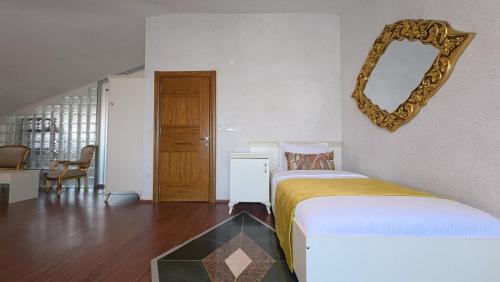 a bedroom with a bed and a mirror on the wall at Casa Villa By Kirte in Eceabat