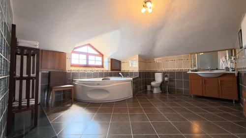 a large bathroom with a large tub and a toilet at Casa Villa By Kirte in Eceabat