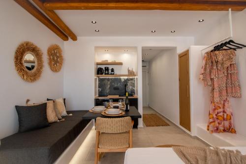 a living room with a couch and a table at Vino luxury suites 2 in Agia Anna Naxos
