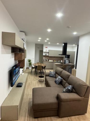 a living room with a couch and a table at Varka Holiday Apartment - Modern Family Friendly and Accessible for All in Marsaxlokk