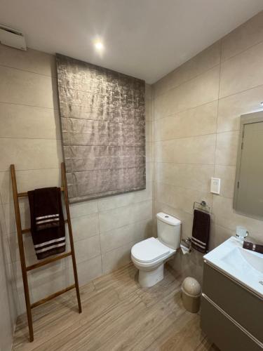 a bathroom with a toilet and a sink at Varka Holiday Apartment - Modern Family Friendly and Accessible for All in Marsaxlokk