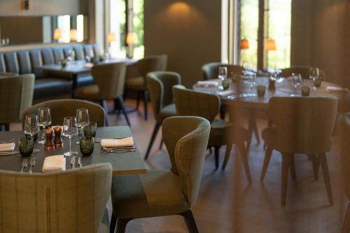 a restaurant with tables and chairs with glasses on them at Bailiffgate Hotel in Alnwick