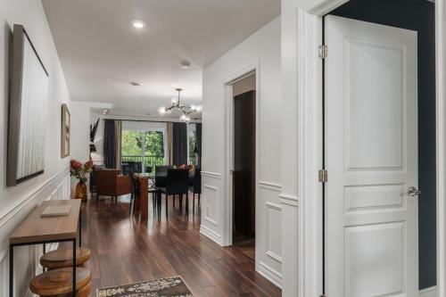 a hallway of a home with a dining room at 2 bedroom suite with views of Sommets St-Sauveur in Saint-Sauveur-des-Monts
