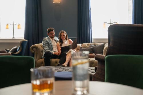 a man and a woman sitting on a couch at Bailiffgate Hotel in Alnwick